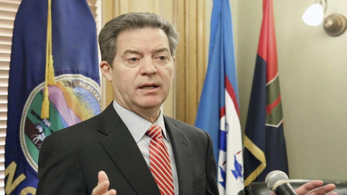 Gov. Sam Brownback takes questions from the media after signing the veto of the tax bill sent to him from the Legislature in Topeka on Feb. 22.