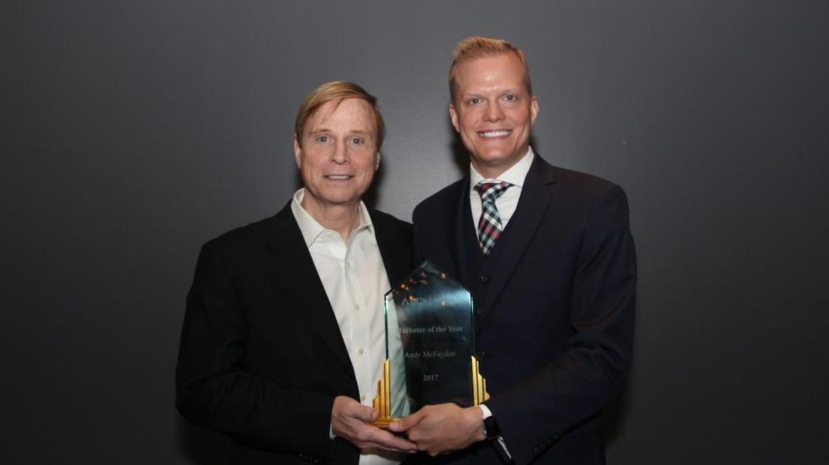 Andy McFayden, right, was named the 2017 Marketer of the Year by the Wichita American Marketing Association. He is seen here holding the award with AMA national president Russ Klein.