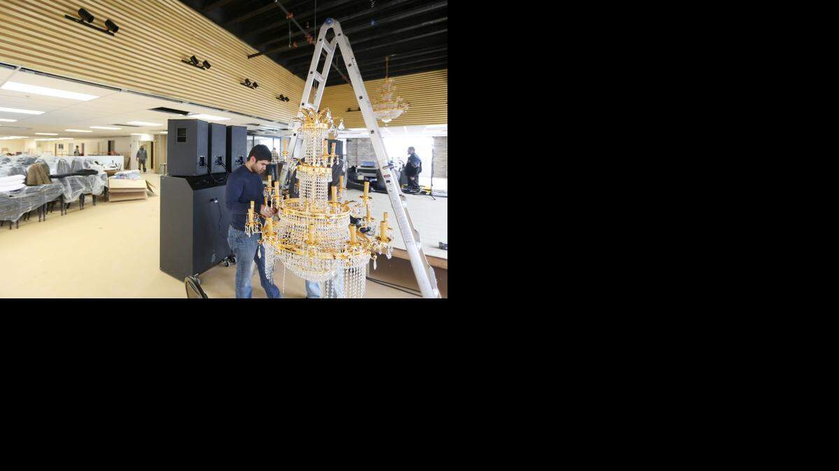 
Najib Sleiman assembles a chandelier to hang in the Skyline Venue on the 10th floor of Sutton Place. The renovation of the space is being done in time for a Wednesday night fundraiser for the Mayflower Clinic. A public grand opening is being planned for Jan. 23. 
