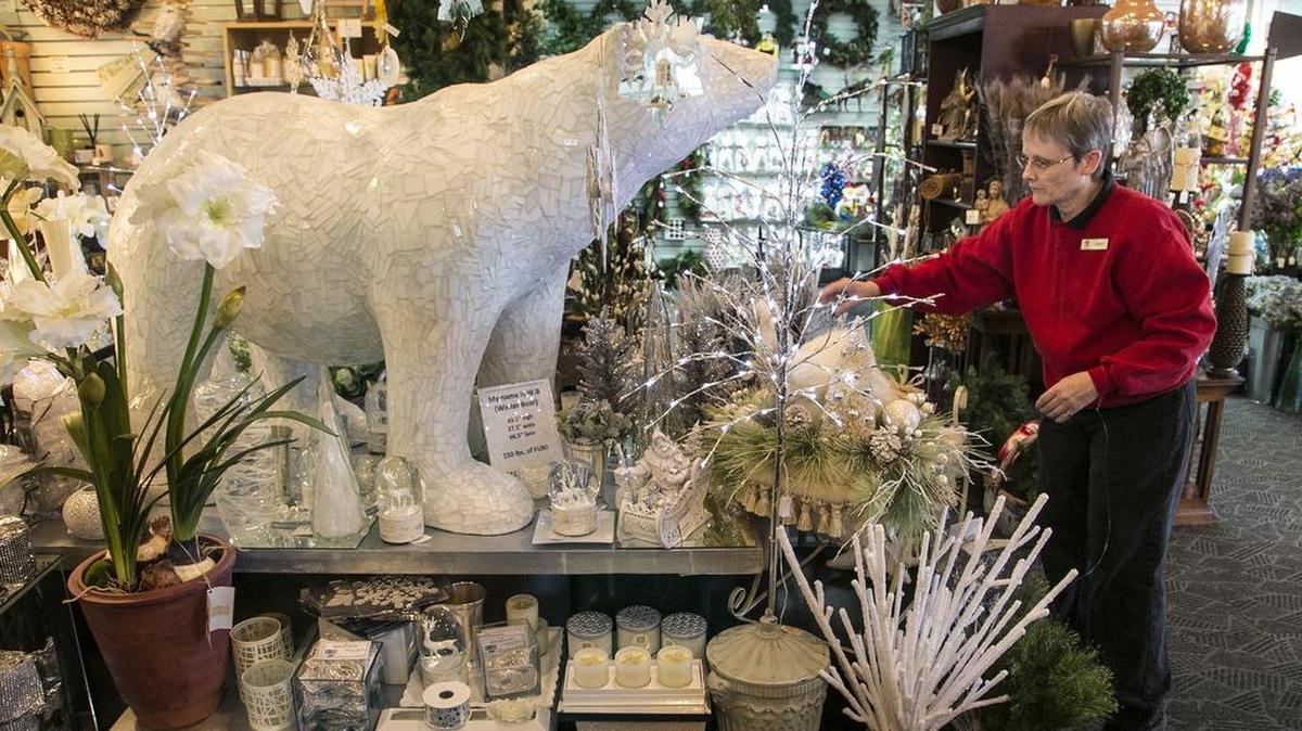 Floor designer Cindy Dennis readies a display at Susan’s in Lincoln Heights Village shopping center on Nov. 27, 2015. Small Business Saturday is a push to get consumers to buy local as the holiday shopping season kicks into high gear.