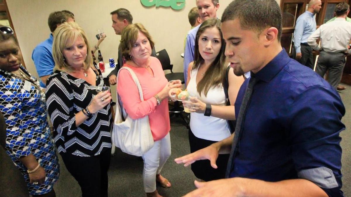KingFit founder and CEO Miguel Johns, right, explains his preventive health and performance program during an e2e Accelerator open house in July.