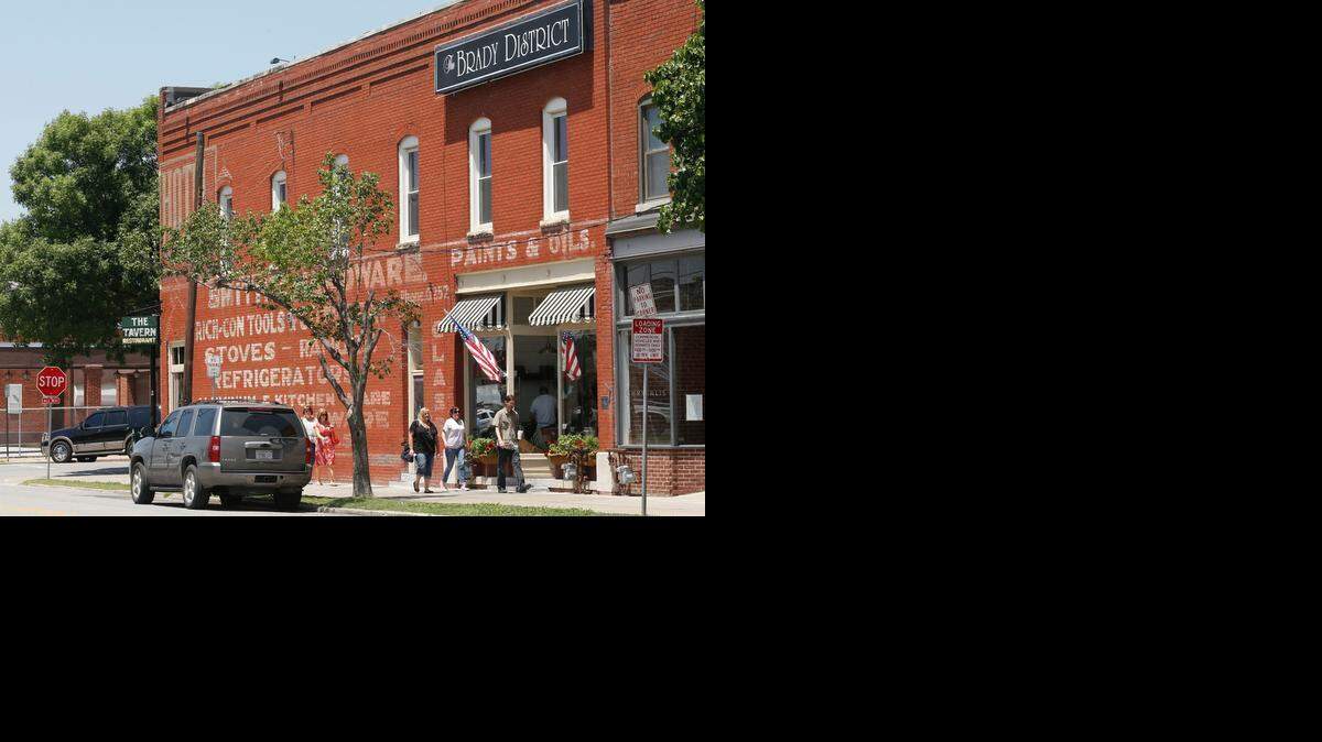 
People walk past The Tavern in the Brady Arts District in Tulsa, Okla., in July 2013. The Brady Arts District is part of a reinvigorated downtown Tulsa.
