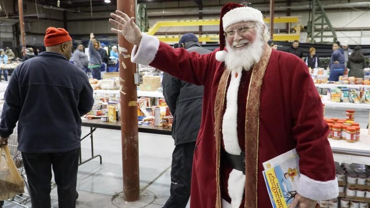 Frank Akerman waves to people at Operation Holiday’s distribution center in 2016.