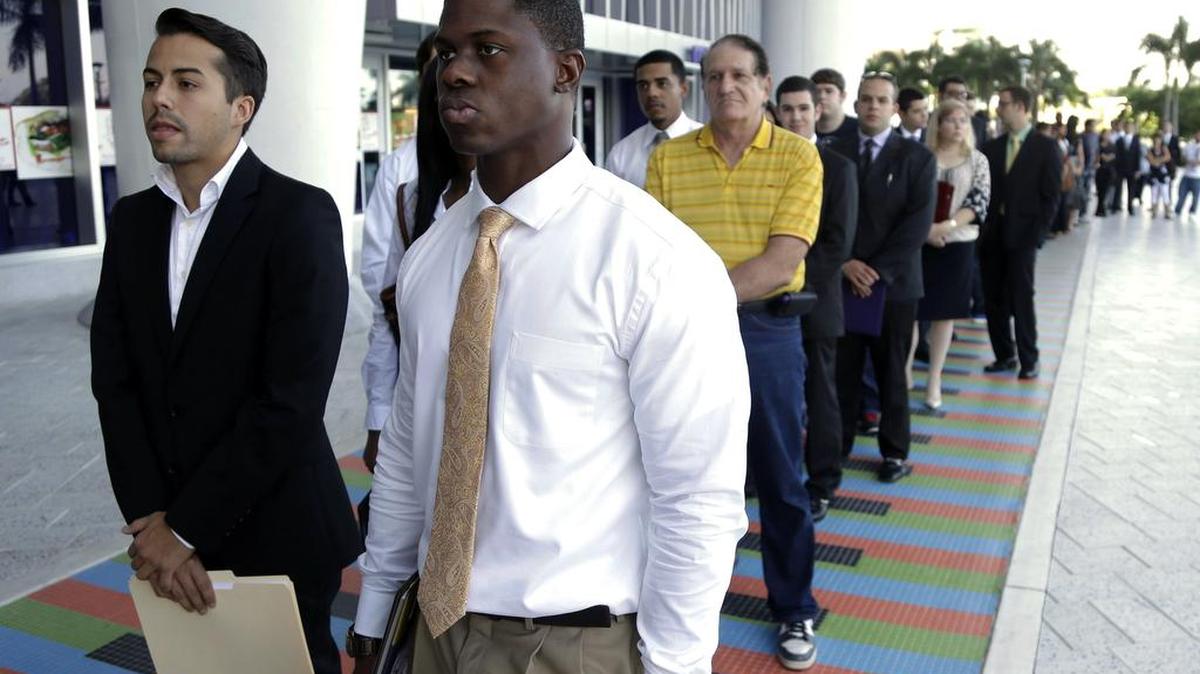 Luis Mendez, left, and Maurice Mike wait in line at a jobs fair in Miami. Job openings rose 2 percent to 5.8 million, the Labor Department said Wednesday, June 8, 2016, matching a record high. Yet hiring slipped for the second straight month to just under 5.1 million.