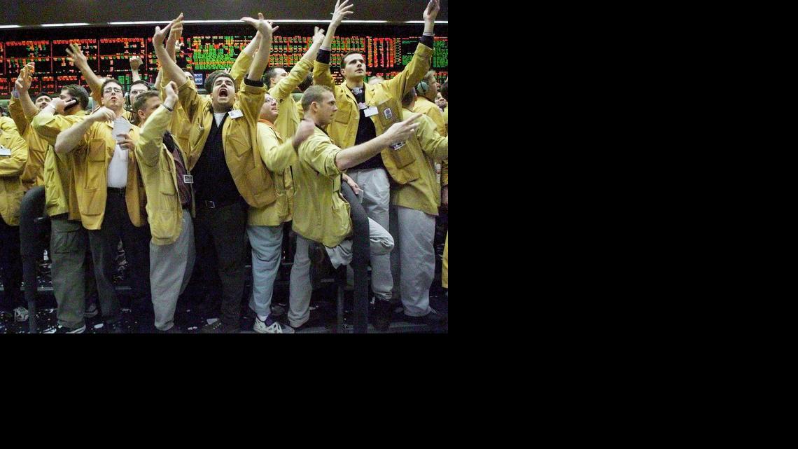 
In this Dec. 21, 1999, file photo, Nicholas Torres, center, shouts an order in the eurodollar pit at the Chicago Mercantile Exchange. Floor trading has shrunk to a fraction of its volume from two decades ago as faster, cheaper, computers take over the process of establishing prices on everything from pigs to Exxon Mobil’s stock. 
