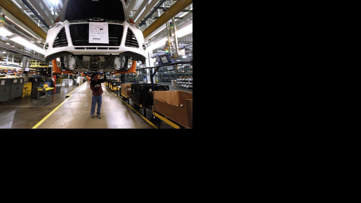
A worker assembles a 2012 Ford Focus at the Ford Michigan Assembly plant in Wayne, Mich., in 2011. After years during which workers saw few or no raises, it appears that more workers could see bigger paychecks in the months to come.
