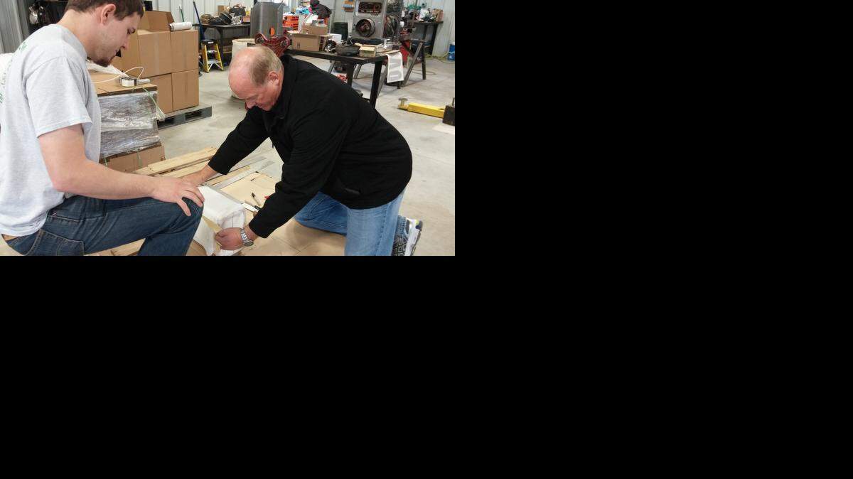 
Ethan Eck, left, and Ralph Lagergren sometimes work out design changes for their device on a piece of cardboard.

