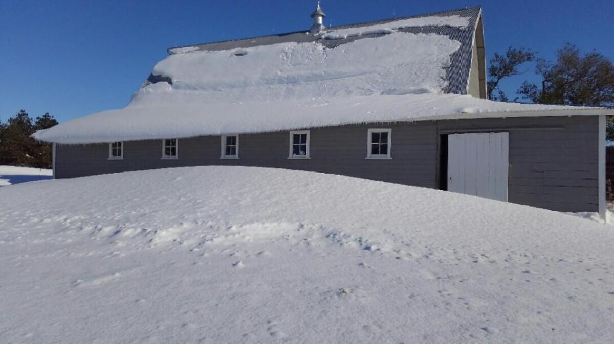 Drifts were piled high Monday at the Millershaski farm in western Kansas.