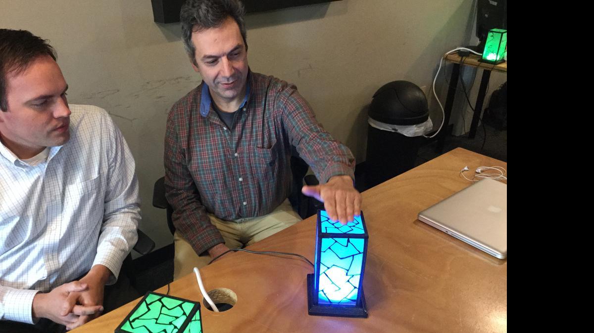
Barrett Morgan, left, and John Harrison, creators of Filimin, demonstrate their Wi-Fi connected lamps.
