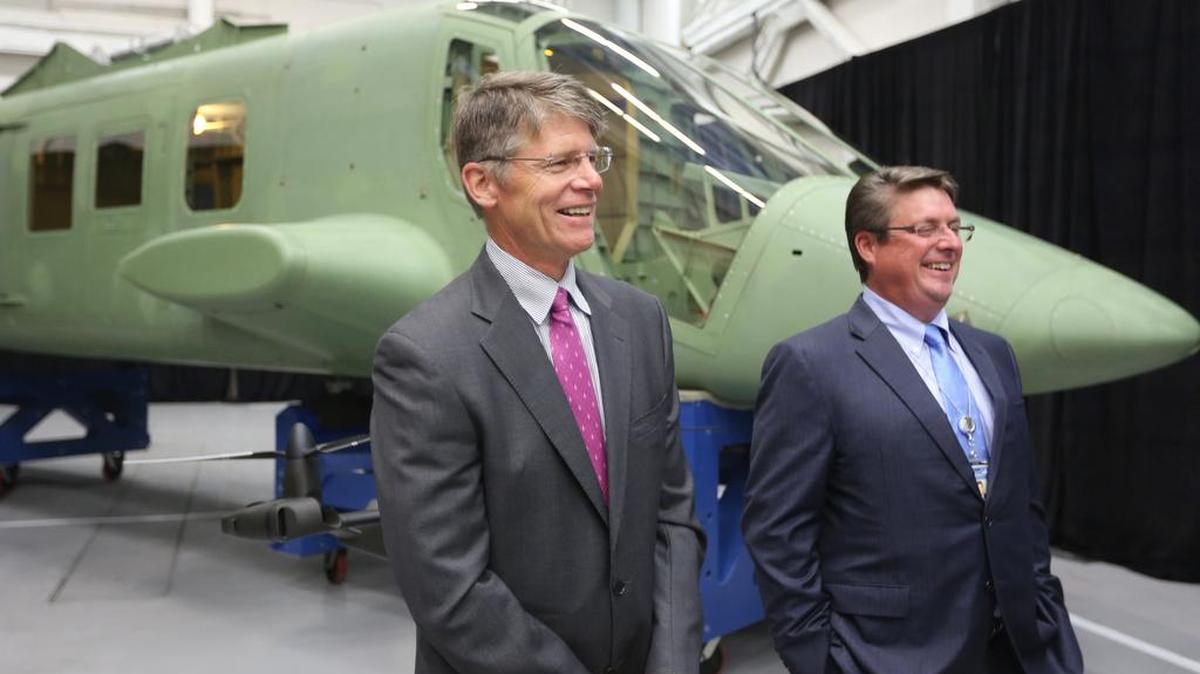 Phil Anderson, right, of Spirit AeroSystems, and Bell CEO John Garrison, are photographed in September 2015. Spirit said in a filing with the Securities and Exchange Commission that Anderson will leave the company May 31.
