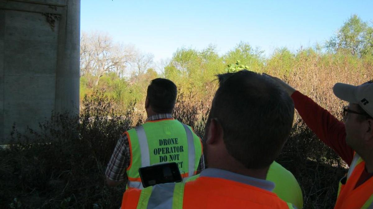 Inspectors from the Kansas Department of Transportation use a drone to examine a bridge as part of a new testing program the agency has launched.