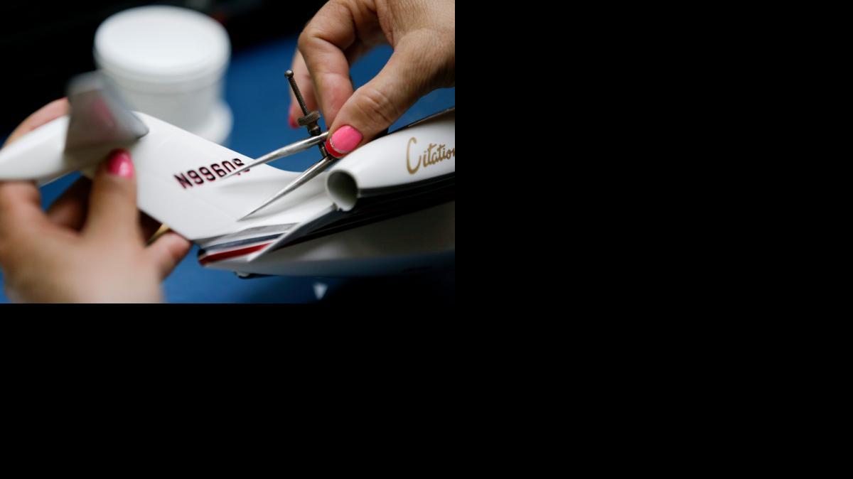 
A worker checks the decal on a model plane at Pacific Miniatures in Fullerton, Calif. The models are a popular collectible throughout the aviation industry.
