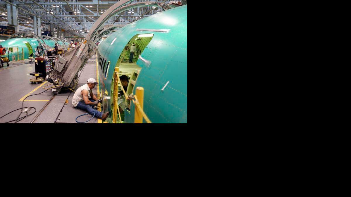 
Spirit AeroSystems employees work on a 737 in June 2014.
