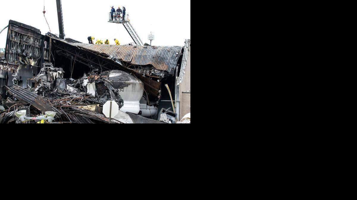 
Contractors hired by the National Transportation and Safety Board work to remove parts of the King Air that crashed into the roof of the FlightSafety building last week. The damage to the building and the simulators it housed will affect training for Cessna pilots.
