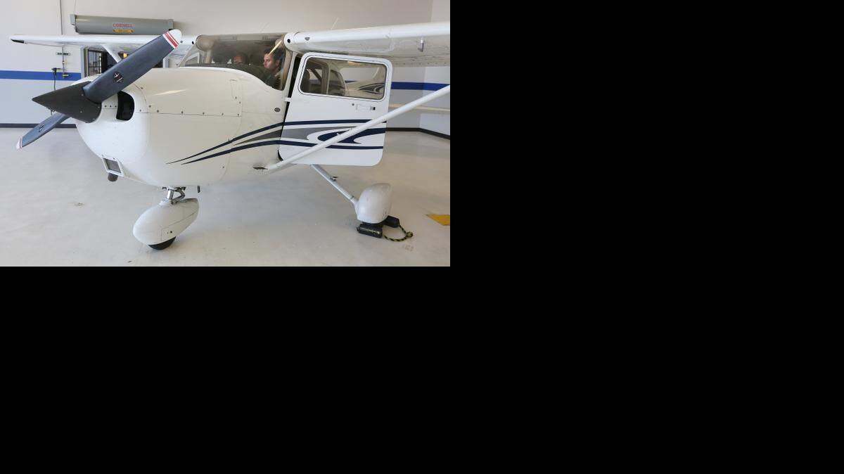
Kirby Ortega, left, director of flight operations at Yingling Aviation, works with his student Andrew Nichols inside a Cessna 172. Nichols is a pilot working on his instrument rating. Pilots who want to advance their training to fly for regional airlines are required to have 1,500 flight hours, up from 250. 
