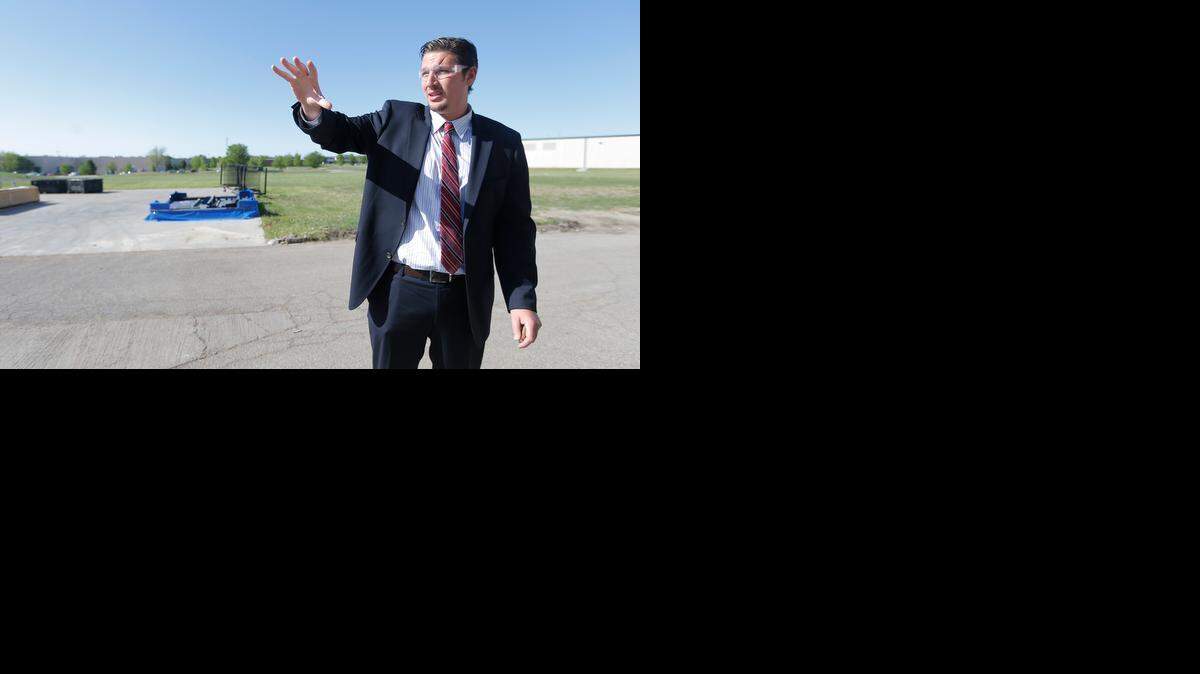 
Hocine Benaoum, an official with French aerospace company Figeac-Aero, points out potential expansion space at Sonaca NMF during a site visit in May 2014.
