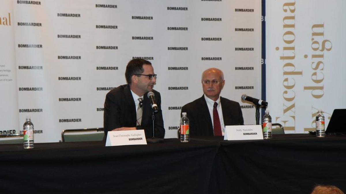 From left, Jean-Christophe Gallagher, Bombardier Business Aircraft vice president of customer experience, and Andy Nureddin, vice president of customer support and training, talk about the company’s service center plans Monday morning in Orlando, Fla.