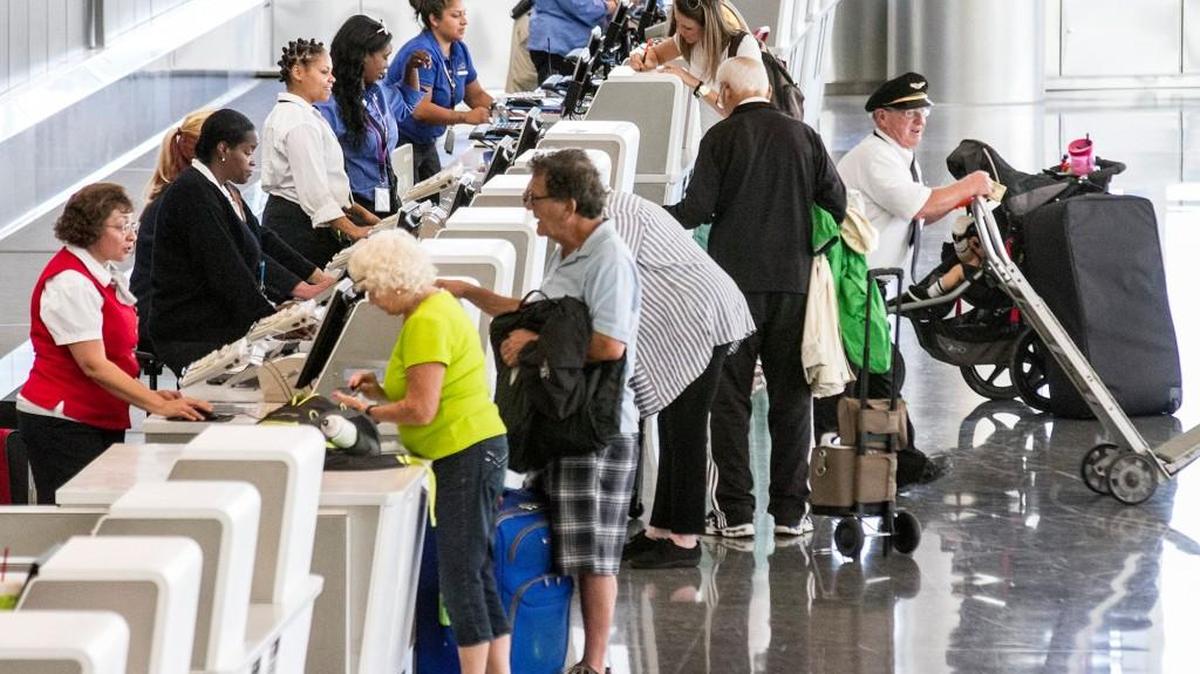 Travelers line up at the ticket counters in the terminal of the Wichita Eisenhower National Airport. (Sept. 9, 2015)