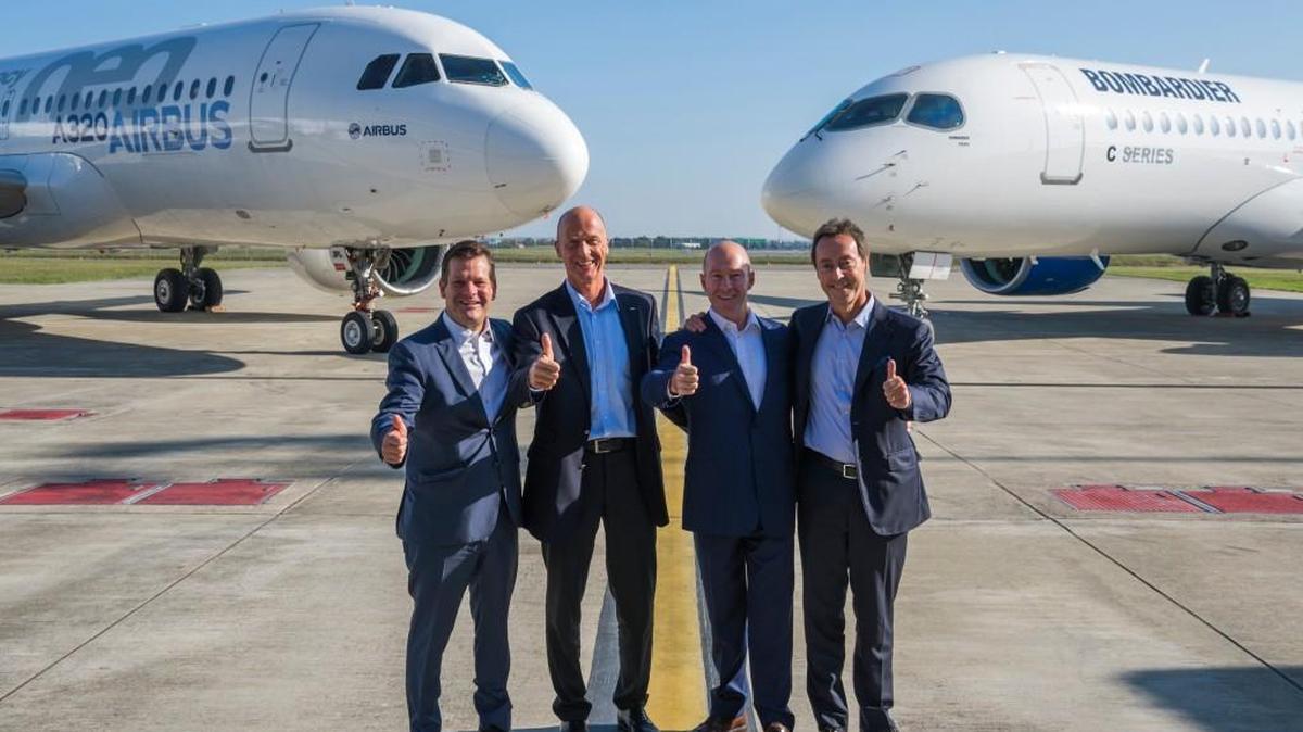 From left, Bombardier chairman Pierre Beaudoin, Airbus CEO Tom Enders, Bombardier CEO Alain Bellemare and Airbus Commercial Aircraft president Fabrice Bregier pose in front of an Airbus A320neo and Bombadier C Series CS300 after the two companies announced Monday plans for Airbus to take a majority stake in the C Series Aircraft Limited Partnership.