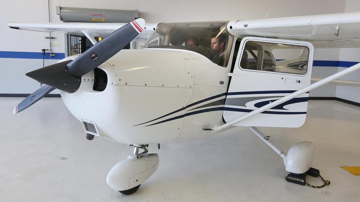 Kirby Ortega, left, director of flight operations at Yingling Aviation, works with his student Andrew Nichols inside a Cessna 172. Nichols is a pilot working on his instrument rating. (Feb. 16, 2015)