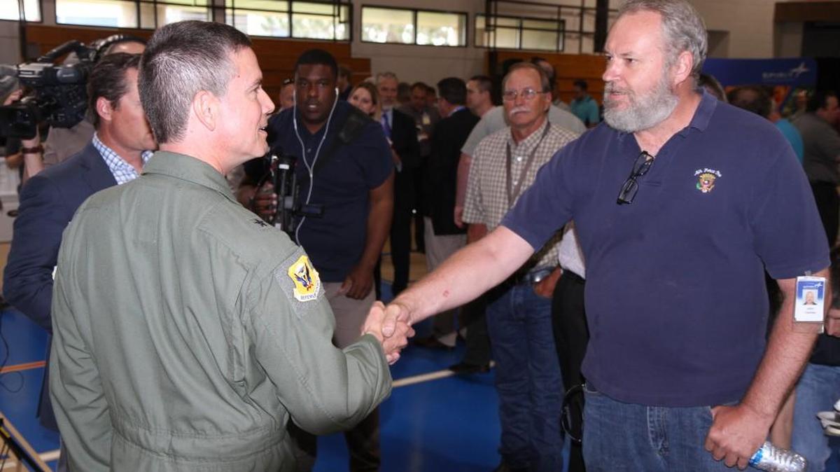 Brig. Gen. Paul Tibbets IV, left, commander of the 509th Bomb Wing at Whiteman Air Force Base, Mo., talks with Spirit AeroSystems employee John Carman at an event last week celebrating Spirit’s work on the new B-21 Raider program. The grandson of “Enola Gay” pilot Brig. Gen. Paul Tibbets Jr. will serve as co-pilot of the restored B-29 “Doc” as it travels from Wichita to Whiteman on Friday for a weekend airshow there.