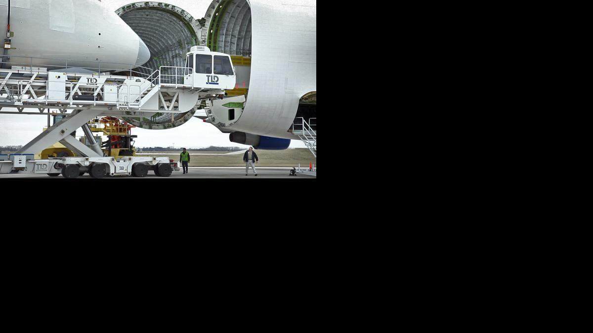 
Boeing workers load a 787 composite forward fuselage section onto Boeing’s Large Cargo Freighter, the Dreamlifter for delivery to Everett, Wash., for final assembly. 
