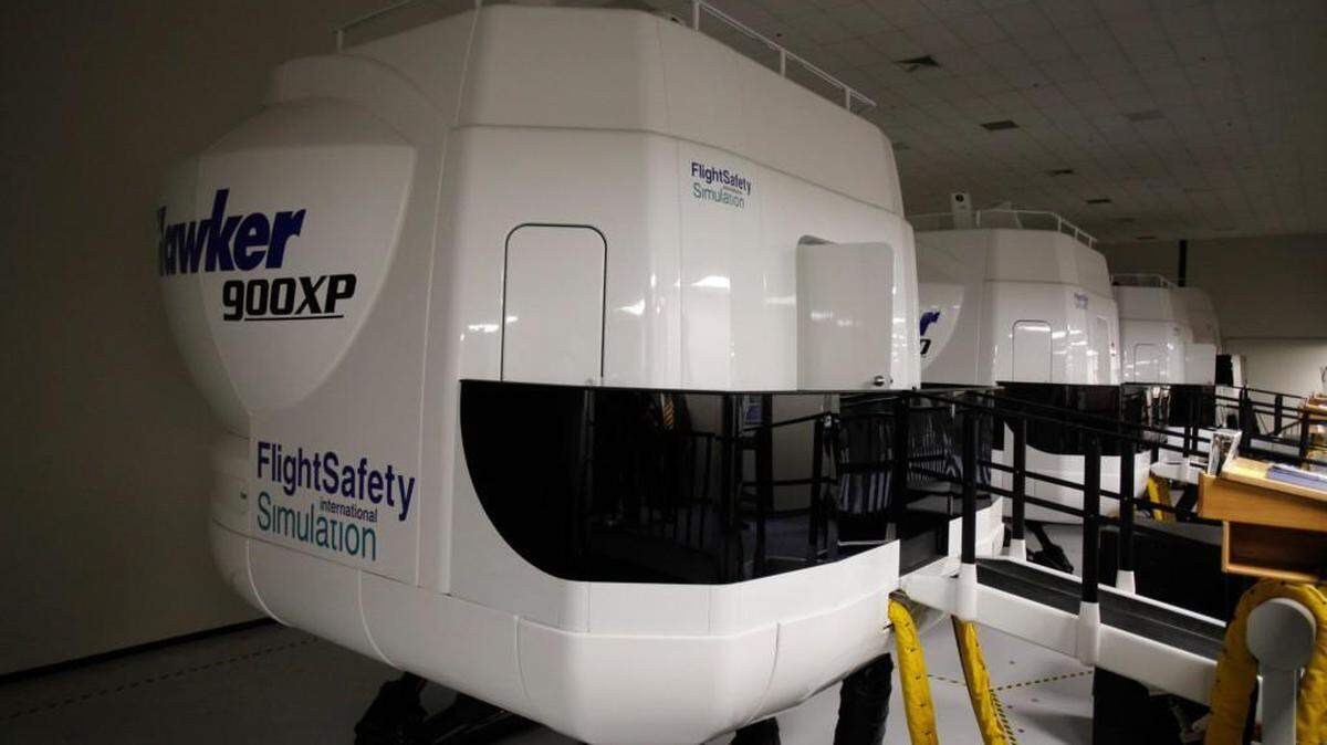 A line of flight simulators at FlightSafety International’s Pilot Learning Center at 9720 E. Central.