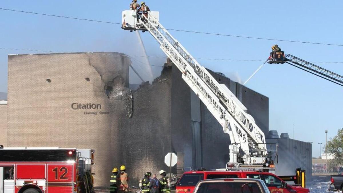 FILE -- Firefighters fight a fire at the Flight Safety and Citation training center building at Mid-Continent Airport in Wichita, Kansas, Thursday October 30, 2014 shortly after a Beechcraft King Air crashed into the building killing several people including the pilot. (Oct. 30, 2014)