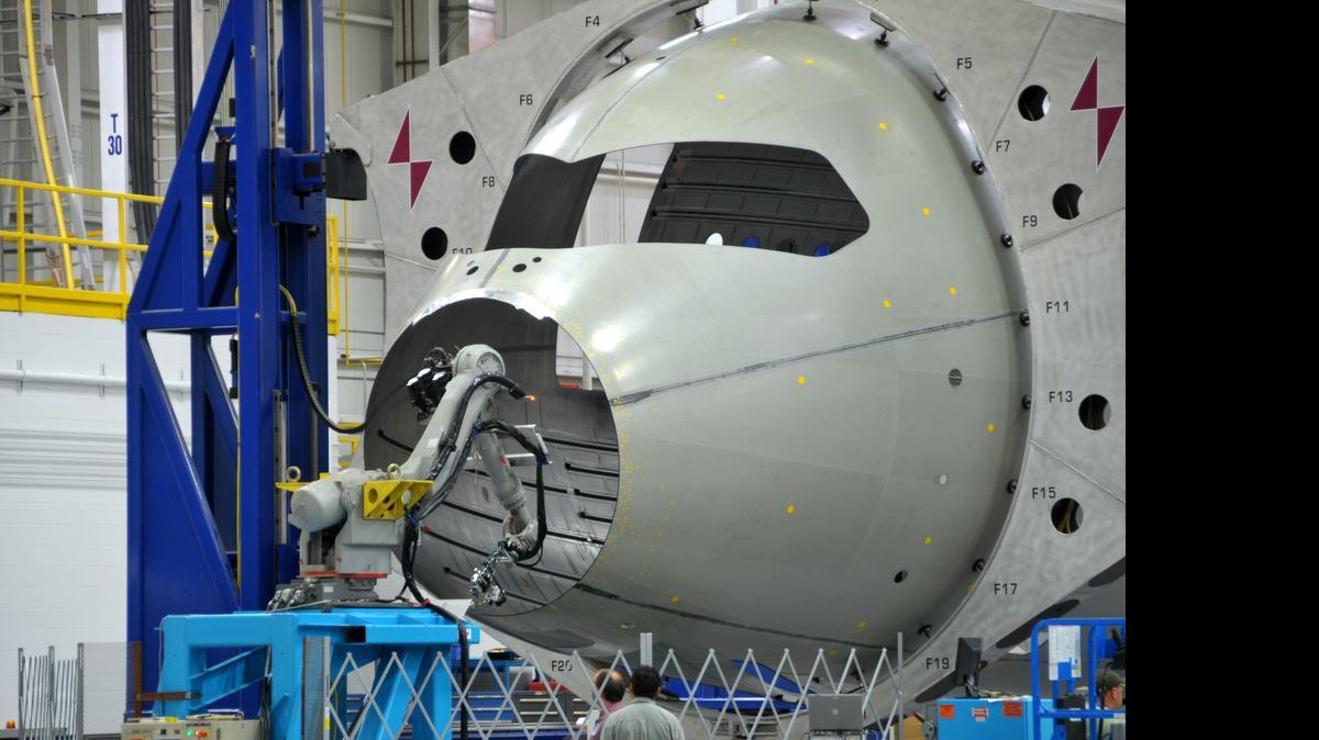 
A robot at Spirit AeroSystems inspects the forward section of a 787 fuselage for any irregularities in the composite structure. The robot is used to access hard to reach areas of the nose section improving safety, efficiency, and cost of the inspection process.
