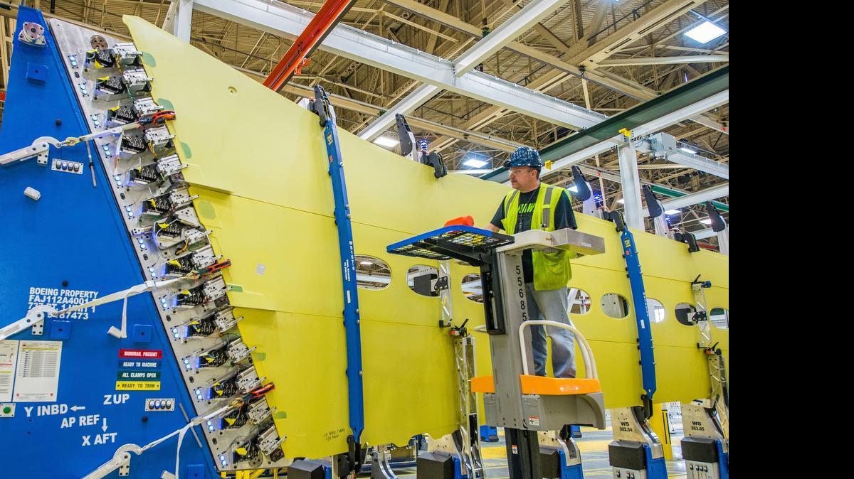
Boeing machine operator Les Nystrom loads 737 MAX wing skin panels and stringers into the new panel assembly line that uses automation to drill holes and install fasteners in the upper and lower wing panels.
