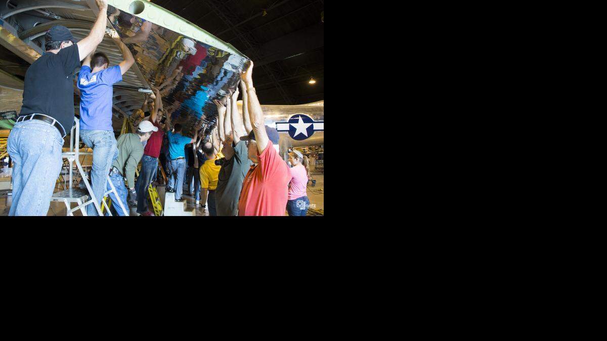 
Volunteers install the flaps on the B-29 Superfortress known as “Doc.” The plane is being restored inside a Boeing Wichita hangar. 
