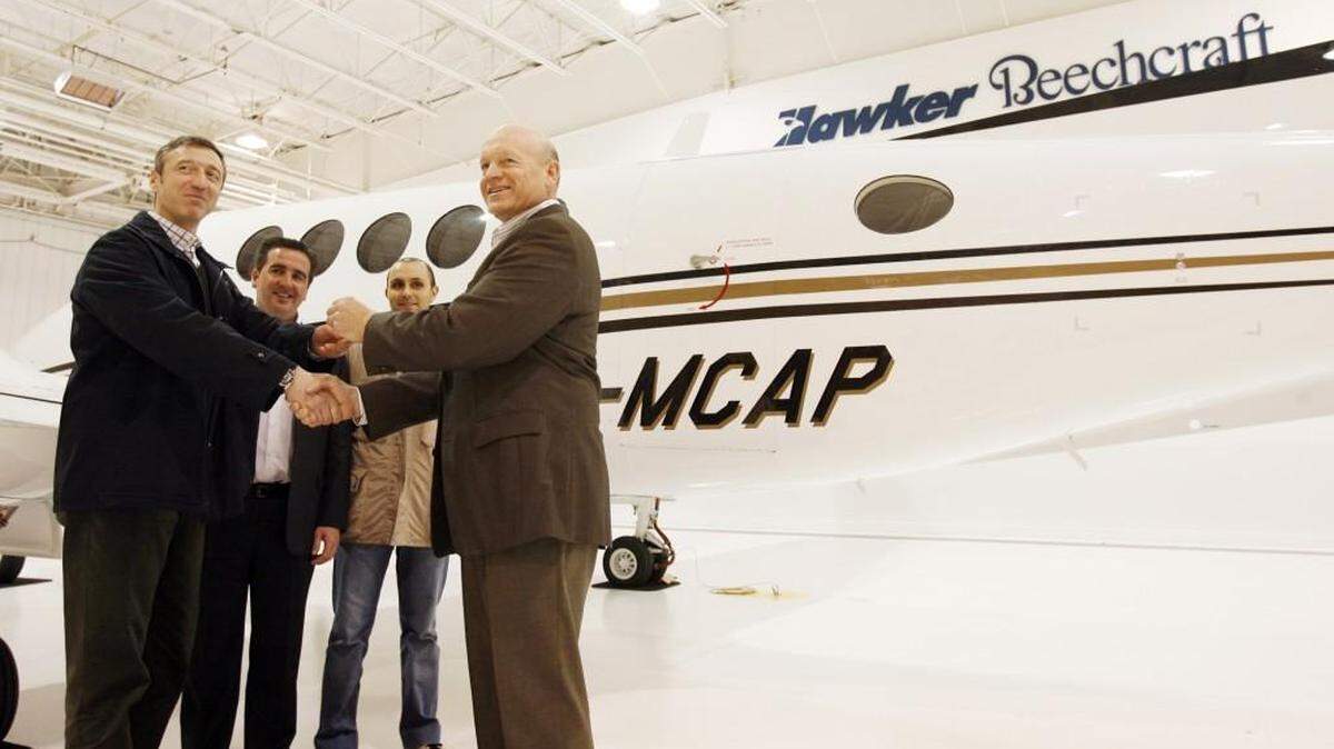 
From left, Maurizio Neri of Modena Capitale Aviation in Italy, Sean McGeough, Hawker Beechcraft vice president of international sales for Hawker Beechcraft, Matteo Di Monte of Modena Capitale and Hawker Beechcraft CEO Jim Schuster pose for a photo as Shuster delivers the keys to a new King Air in this 2007 photo. McGeough has been hired as regional vice president for Aerion, which is developing a supersonic business jet.
