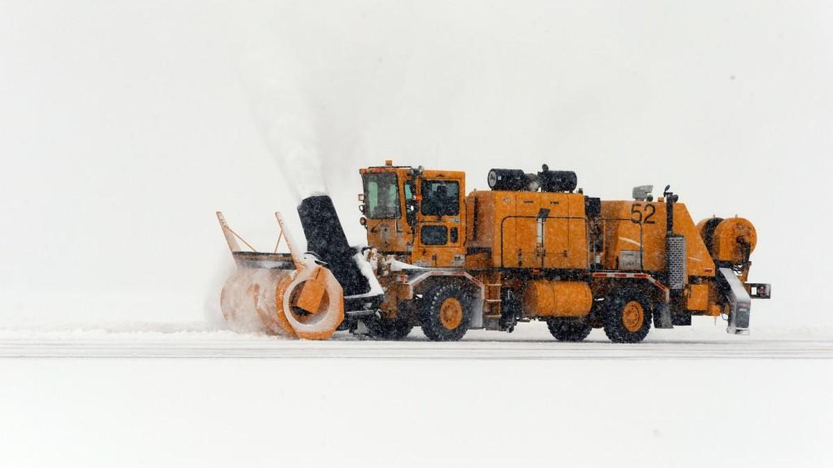 A giant snow blower clears snow on a taxiway at the former Mid-Continent Airport in 2014. Wichita Eisenhower National Airport crews will be practicing snow removal Tuesday morning at the airport.