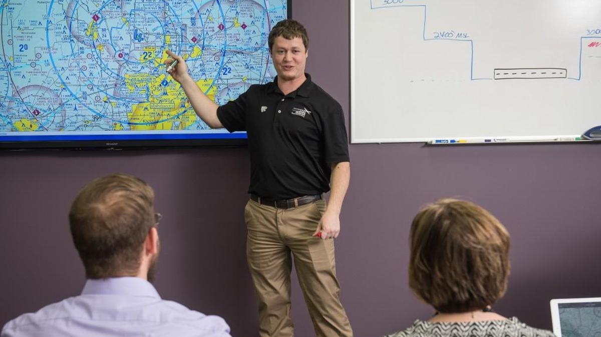 Travis Balthazor, UAS flight operations manager for Kansas State University’s Applied Aviation Research Center, instructs students for the written FAA exam during a Part 107 training course.
