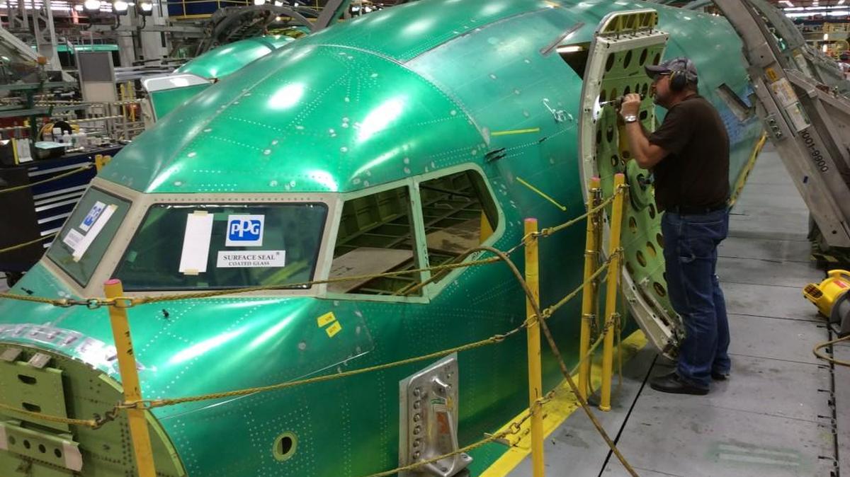 A Spirit AeroSystems employee works on a Boeing 737 fuselage at the company’s Wichita plant on Thursday.