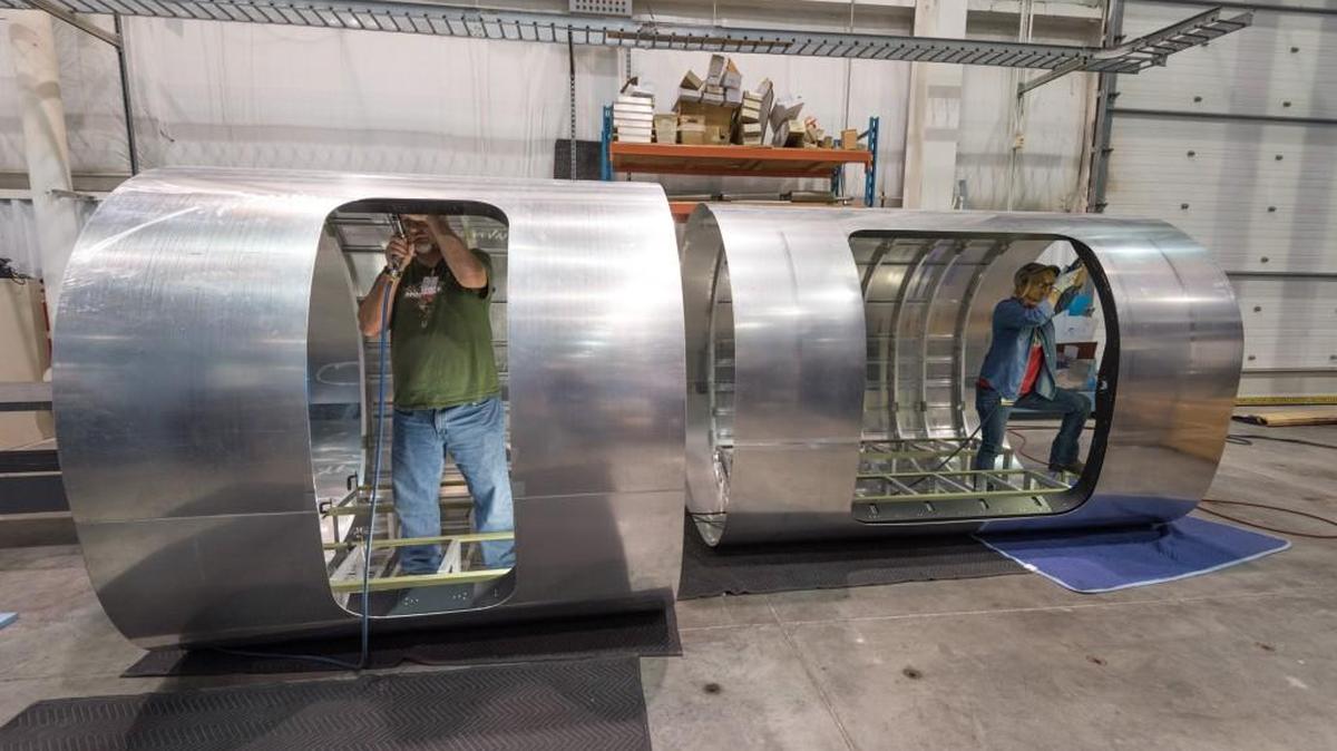 Textron Aviation employees work on parts of the Cessna Denali’s fuselage that will be used for testing.