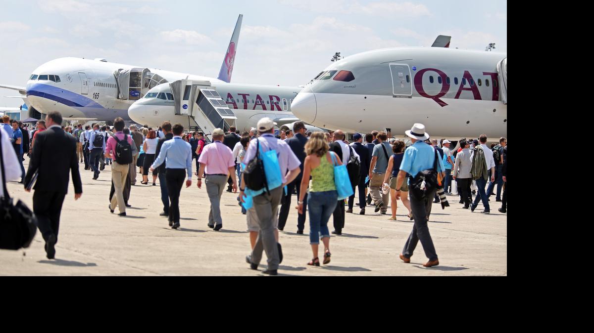 
Visitors walk past planes at the Paris Air Show in Le Bourget, north of Paris, on Wednesday. Some 300,000 aviation professionals and spectators are expected at this week’s Paris Air Show, coming from around the world to make business deals and see dramatic displays of aeronautic prowess and the latest air and space technology. 
