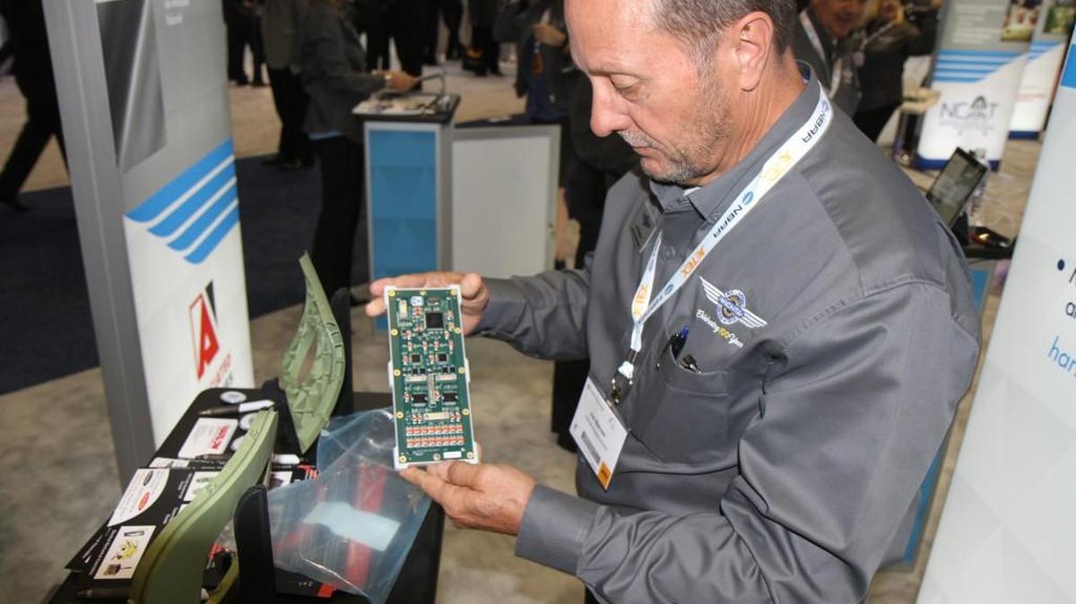 Jim Barnes, president and chief operating officer of Harlow Aerostructures, displays part of the company’s new aircraft auto throttle he is pitching to aircraft manufacturers at the National Business Aviation Association Convention this week in Orlando, Fla. (Nov. 1, 2016)