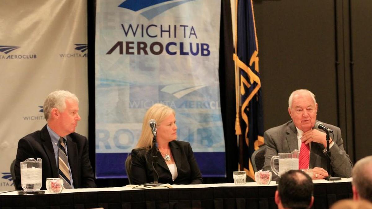 Legendary pilot Clay Lacy, right, tells a story at the Wichita Aeroclub meeting Tuesday as pilots Lee Lauderback and Angela West listen. (Dec. 15, 2015)