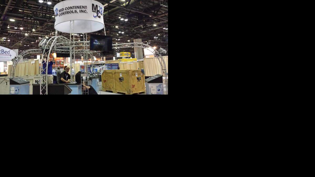 
Workers set up an exhibit for Mid Continent Controls at the National Business Aviation Association in Orlando, Fla., Monday. Mid Continent Control, which is based in Derby, produces cabin management and in-flight entertainment systems for the business aircraft industry. The NBAA show will open to the public Tuesday.
