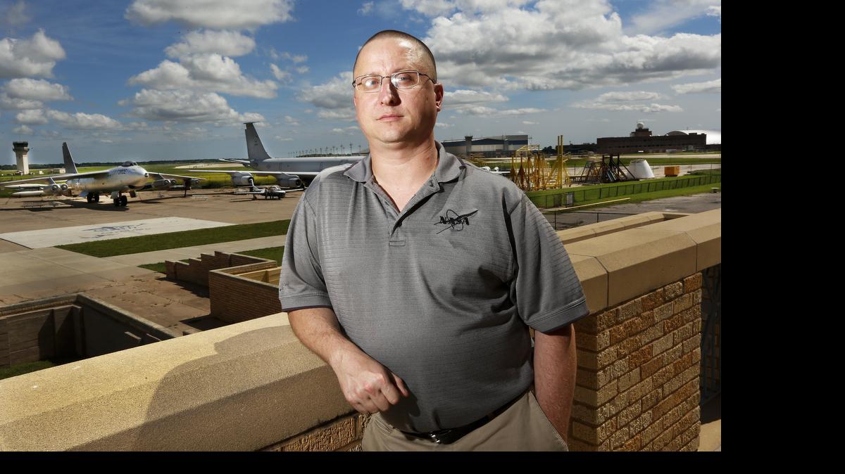 
The new executive director of the Kansas Aviation Museum, Daniel Bateman, stands on the museum balcony.
