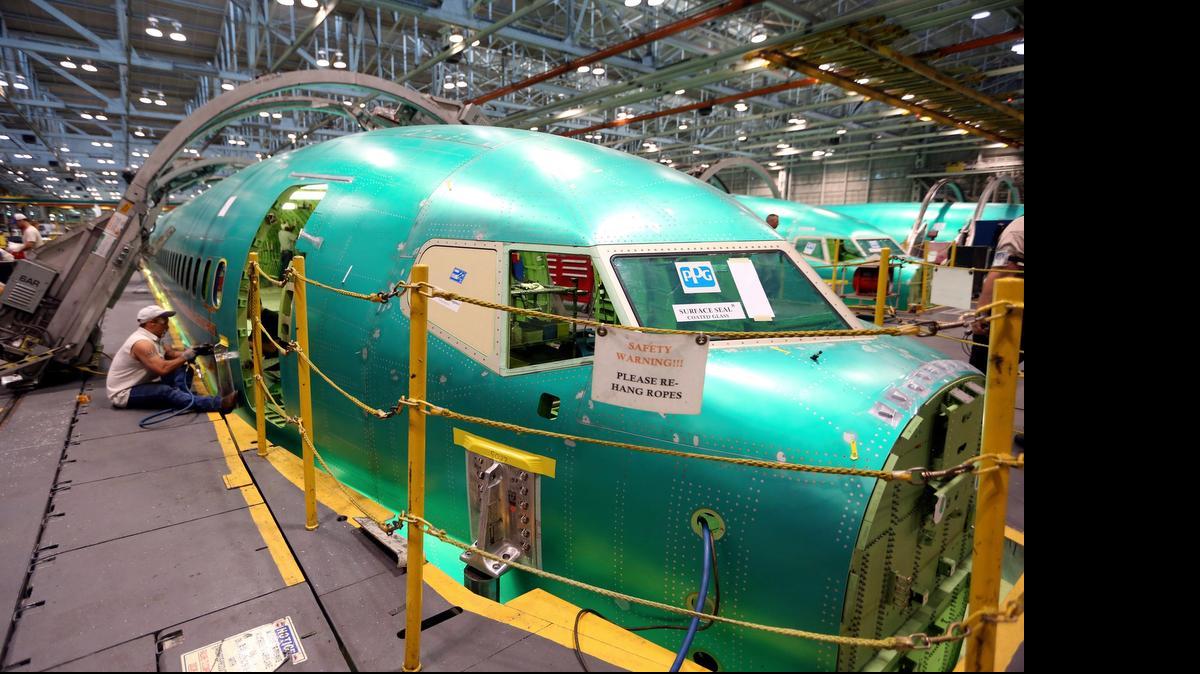 
A Spirit AeroSystems employee works on a Boeing 737. Boeing on Monday reported that its commercial jet deliveries in the second quarter of 2015 were higher than a year ago. (June 11, 2014)
