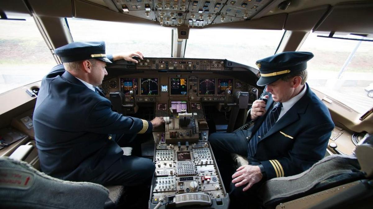 United Airlines Capt. Tommy Holloman, left, and Capt. Chuck Stewart demonstrate radio communications, right, and the Data Communications Data Comm technology, left, from the cockpit of an United Airlines Boeing 777 at Dulles International Airport Air Traffic Control Tower in Sterling, Va., on Sept. 27. Data Comm gives air traffic controllers and pilots the ability to transmit flight plans, clearances, instructions, advisories, flight crew requests, and reports via a digital message service.