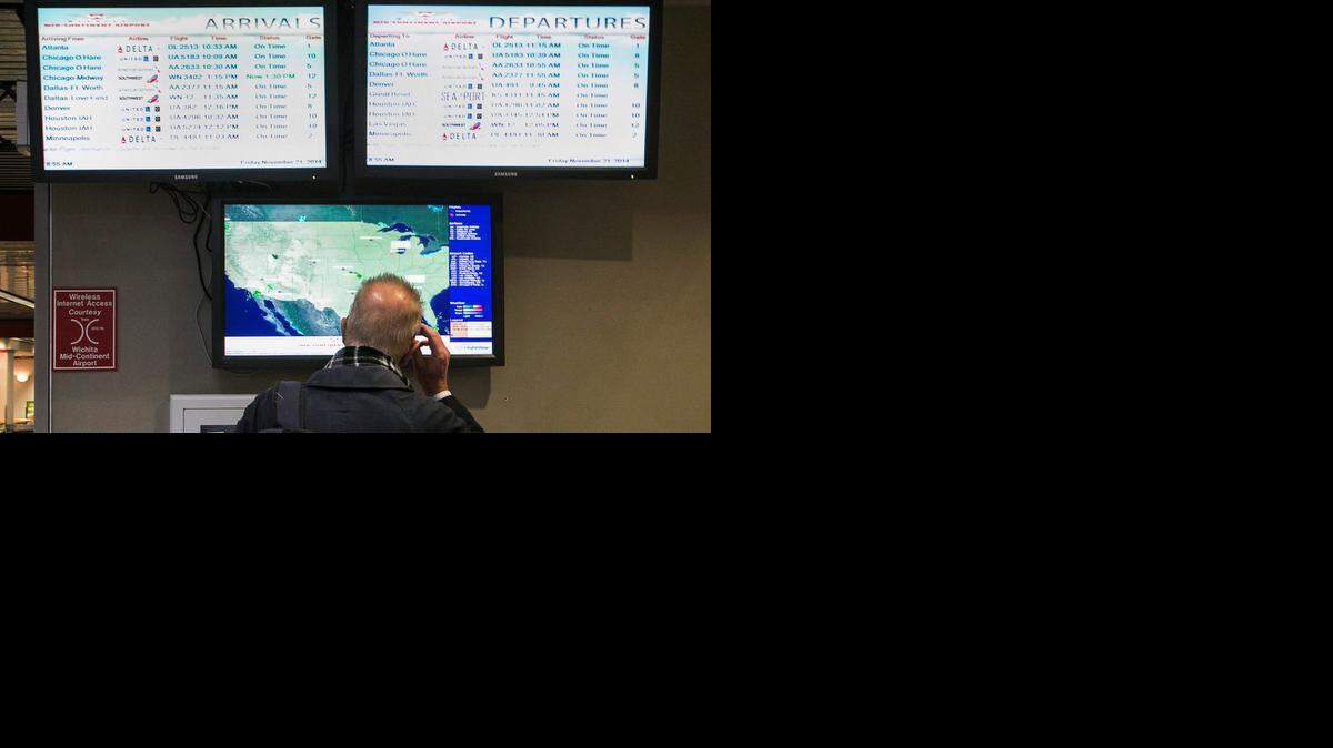 
A traveler looks at the flight status boards at Dwight D. Eisenhower Airport. (Nov. 21, 2014)
