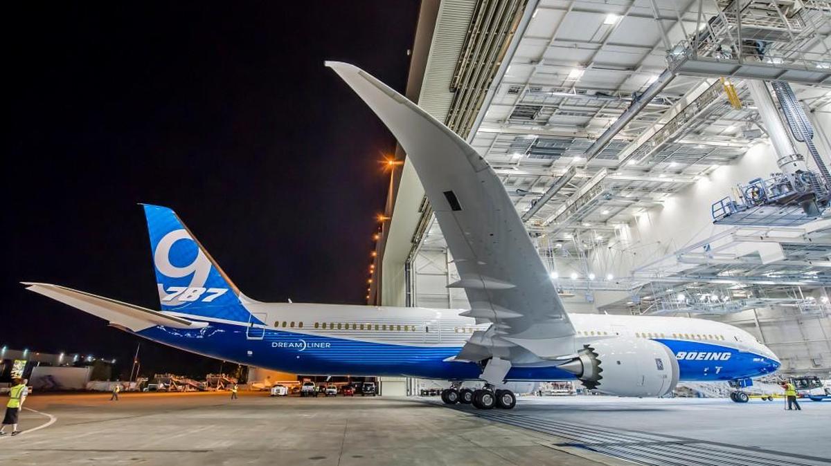 Boeing workers in Washington roll out a 787-9 from the paint hangar.
