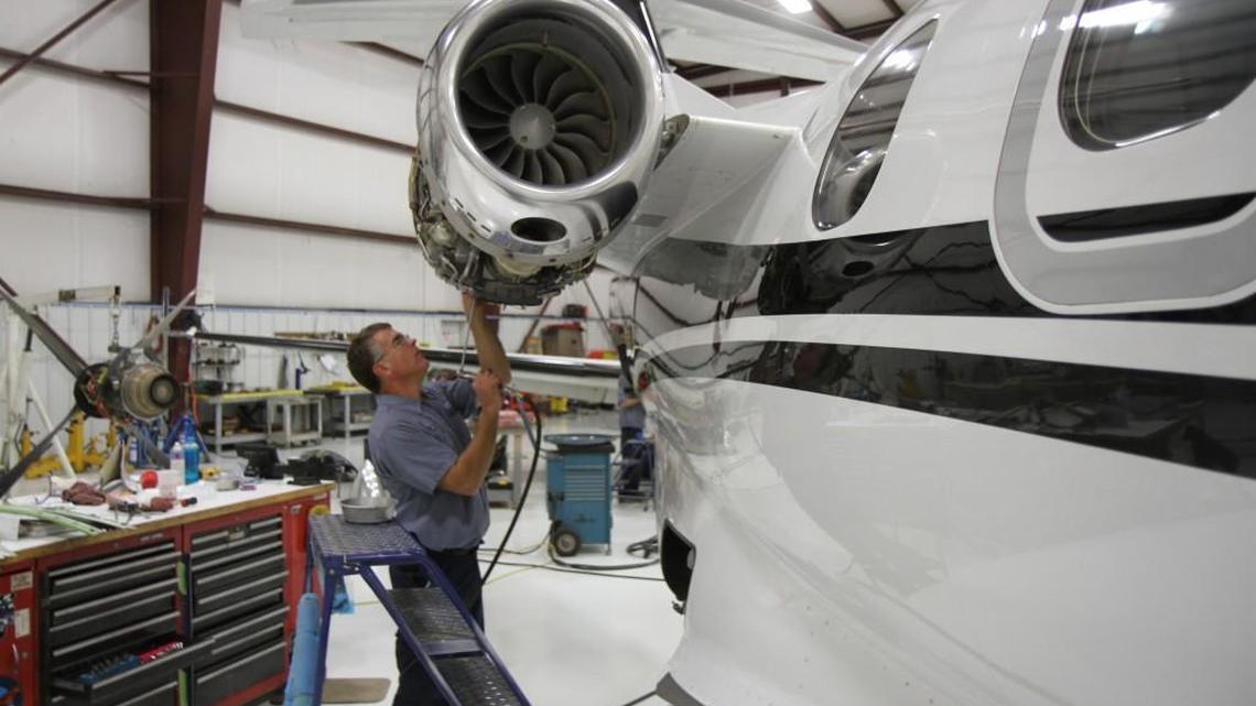 Executive AirShare mechanic Kevin Riedl works on one of the company’s Embraer Phenom 100 business jets on Tuesday afternoon. The fractional aircraft ownership company is promoting its Embraer Authorized Service Center designation since relocating to new and larger facilities from Wichita Eisenhower National Airport.