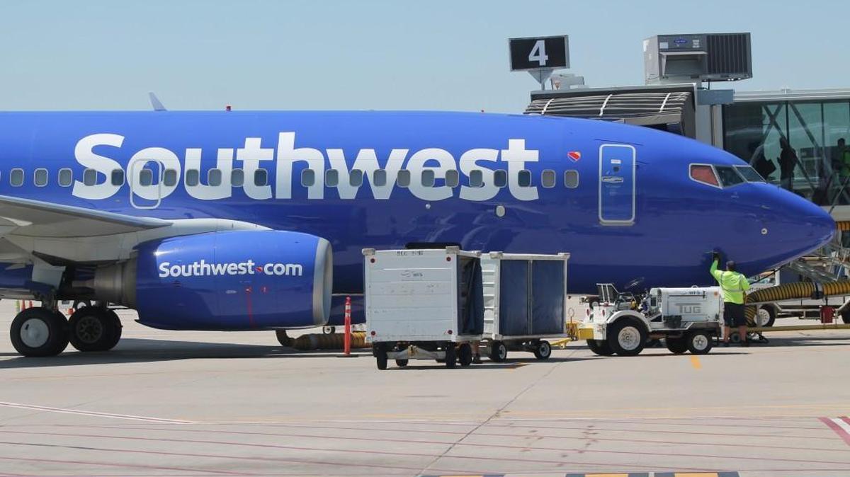 A ground crewman prepares a Southwest Airlines flight for departure from Wichita Eisenhower National Airport in 2017. The Dallas-based airline canceled hundreds of flights over the weekend and Monday, disrupting the plans of many passengers, including some in Wichita.