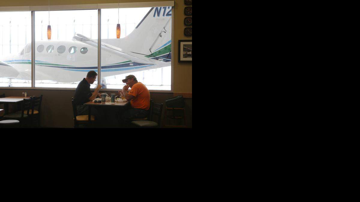 
Diners at Yingling Aviation’s Subway Cafe enjoy the view of a Cessna Conquest I while they eat in the restaurant. (August 26, 2014)
