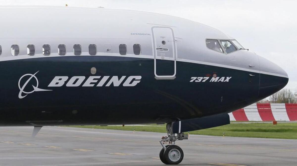 A pilot waves from the flight deck of a Boeing 737 Max 9 as it rolls out for the airplane’s first flight in Renton, Wash. (April 13, 2017)