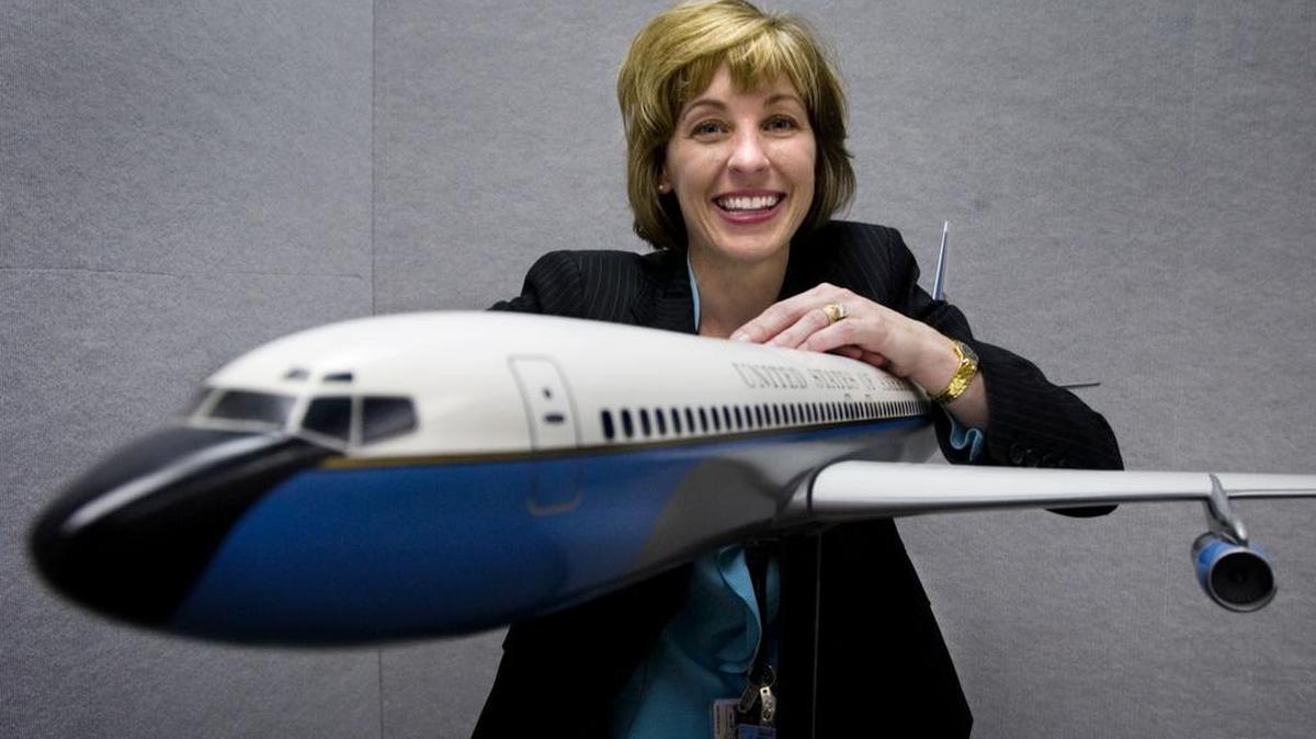 Leanne Caret with a model of a Kennedy-era Air Force One at Boeing Wichita in 2006.